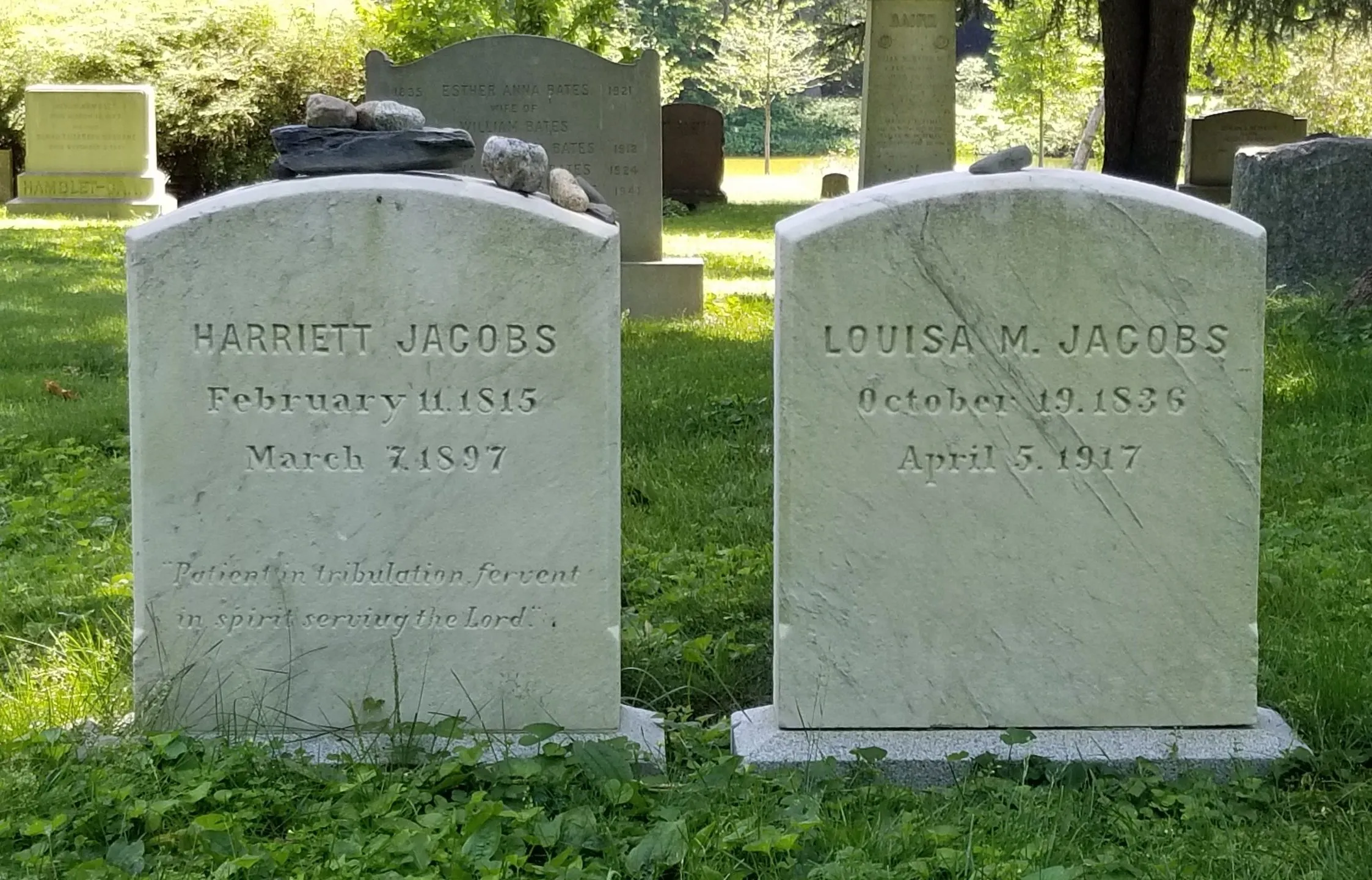 Two gravestones next to each other made of clean, white marble.