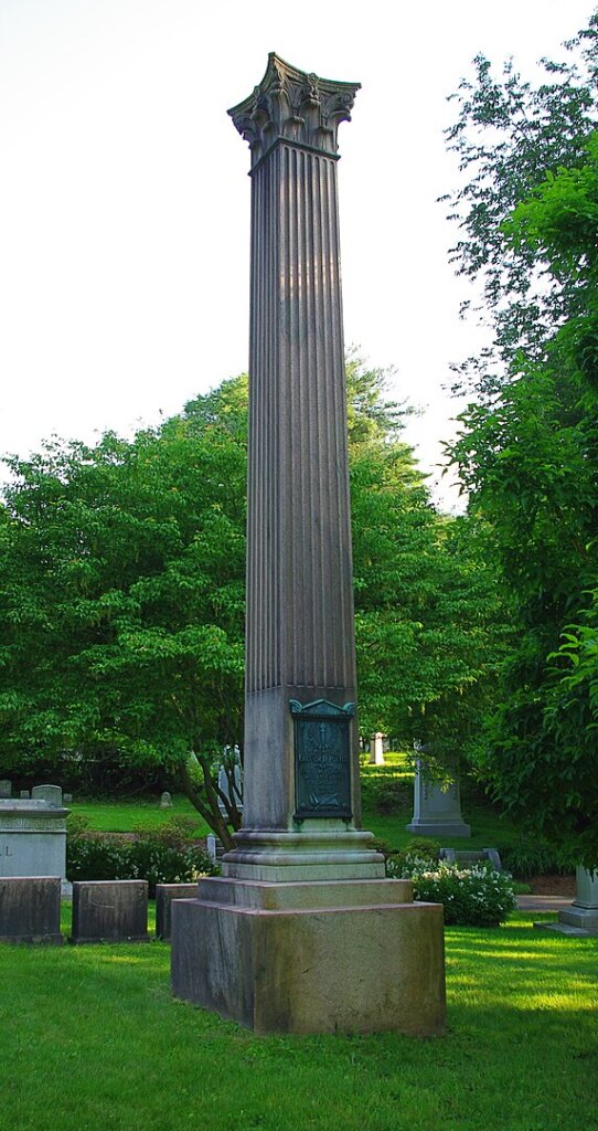 A large column monument in a cemetery
