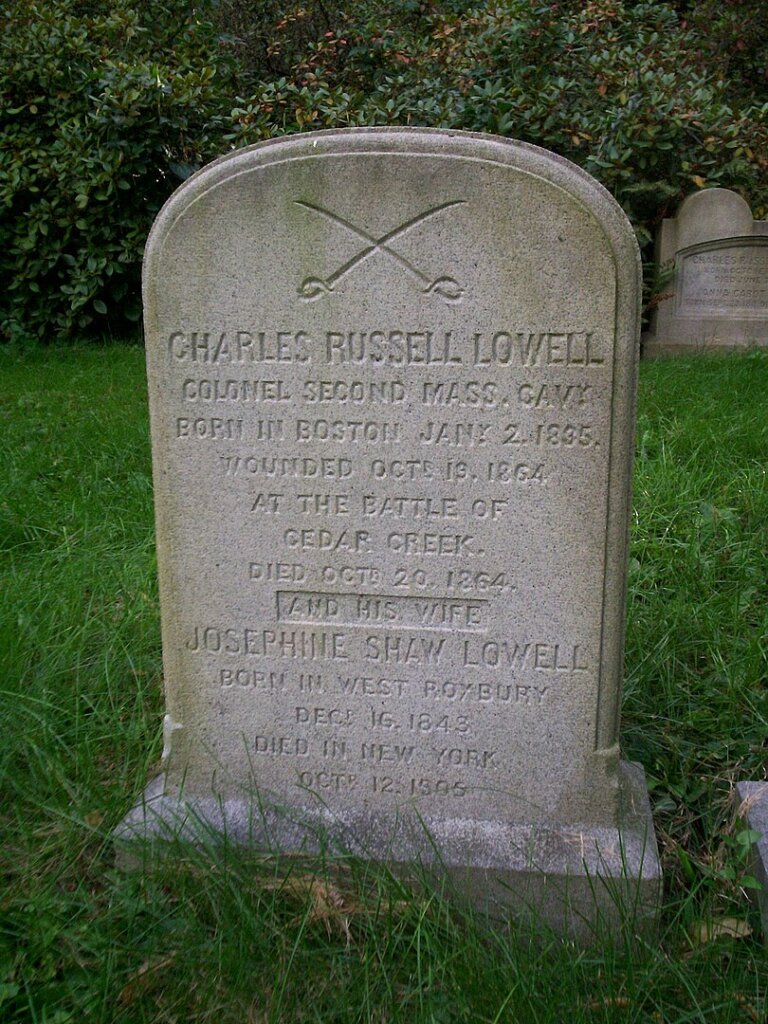 A gravestone with two swords carved into the top