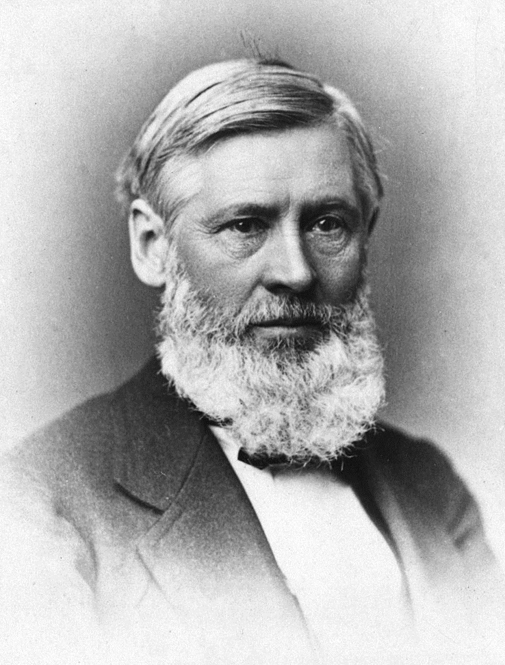 A black and white portrait of an older man with a white beard
