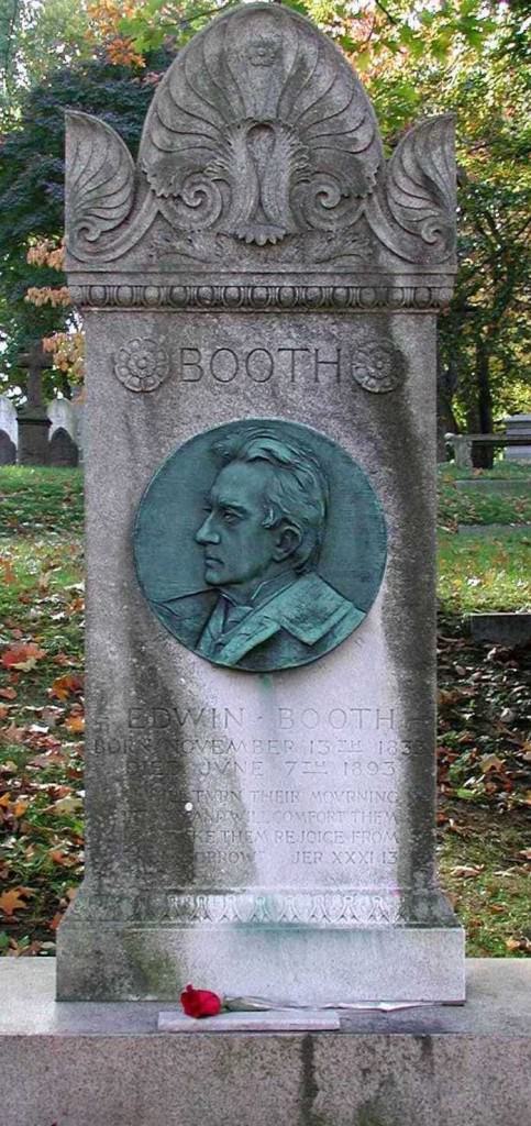 A gravestone with a bronze portrait in a cemetery