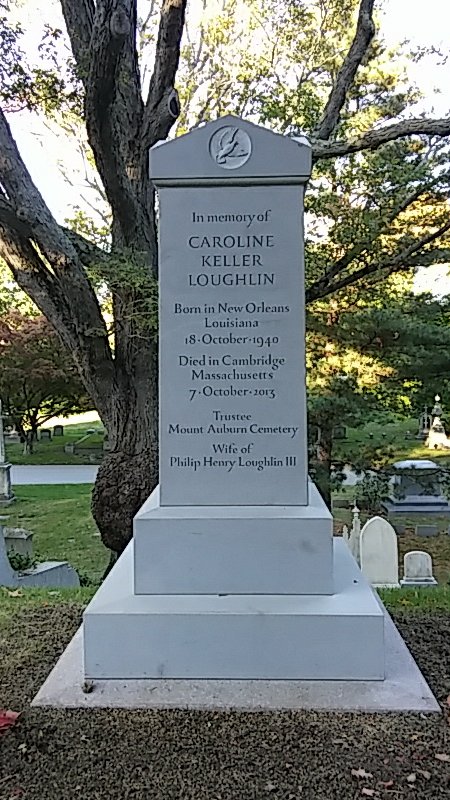 A granite rectangular monument in a cemetery.