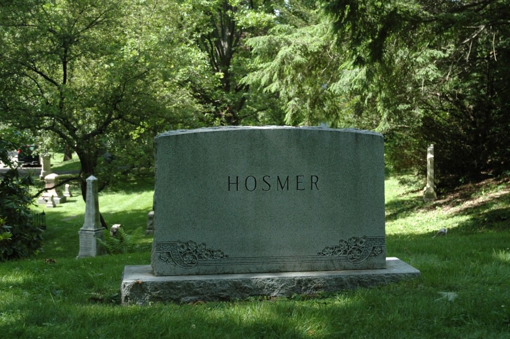 An upright granite gravestone monument in a cemetery. 