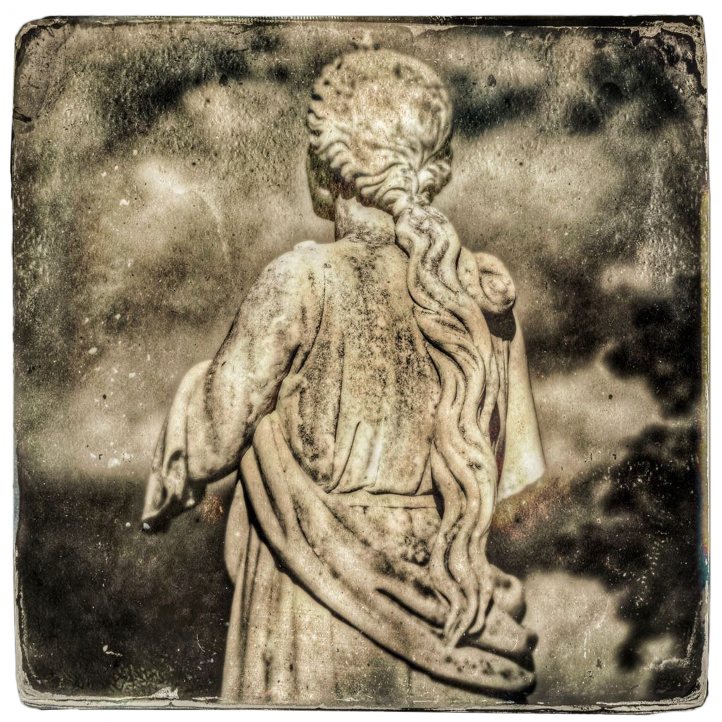 Back of stone woman in robes looking left with curving hair down her back, in sepia tones