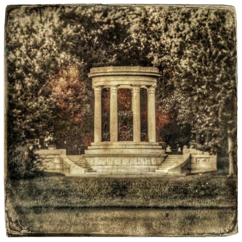 Classical temple with four columns, steps to either side, grass and water in front, framed by tree leaves in sepia tones