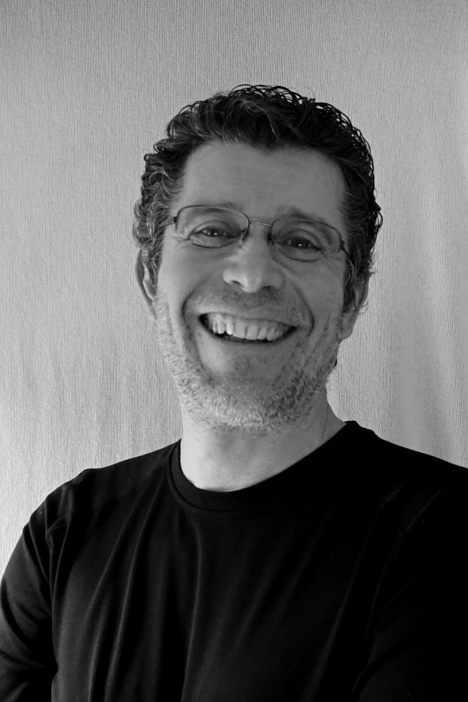 Black-and-white photo of a man smiling